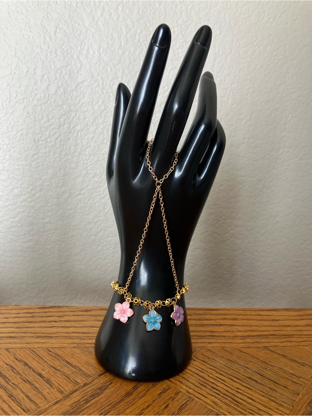 Gold-tone Hand Chain Bracelet with Pink, Blue, and Purple Flower Charms